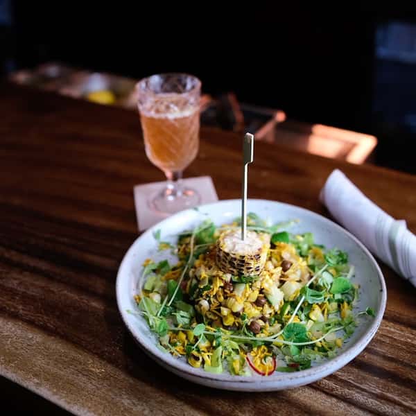 Corn Bhel salad, glass of wine, bar at Chaska