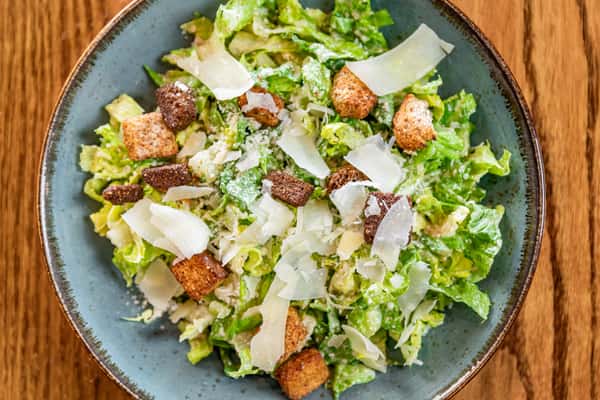 Caesar salad in a bowl on the table