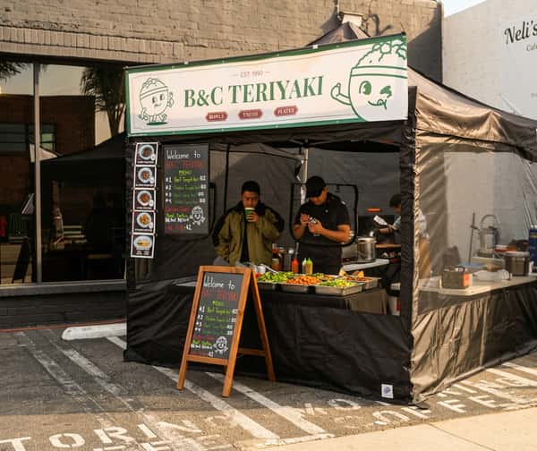 B&C Teriyaki food stand serving teriyaki bowls, tacos, and plates at an outdoor event