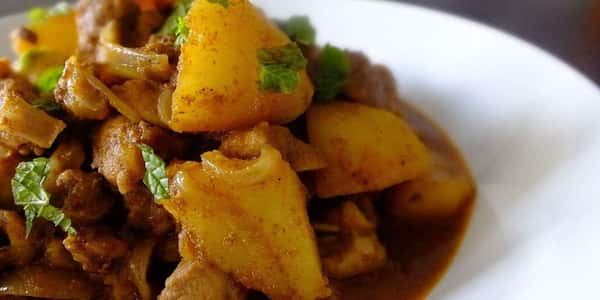 Curry with potatoes and corriander garnish