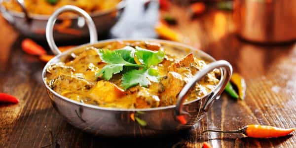Creamy paneer curry in a traditional Indian pot