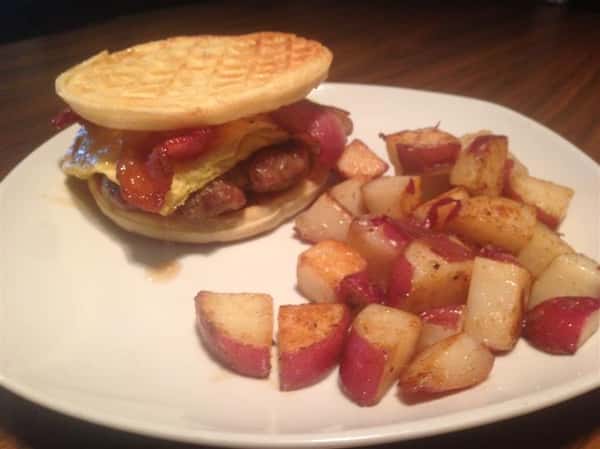 A beef burger served in a crumbet, served with red skinned potatoes