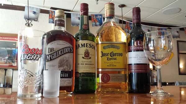 Four bottles of whiskies, tequilas and other drinks