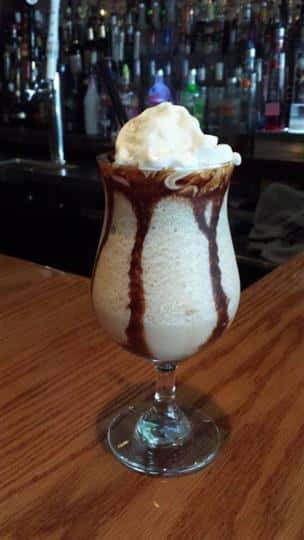 Vanilla drink with chocolate sauce and whipped cream