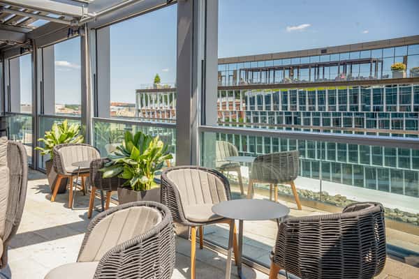 Stylish indoor lounge seating with waterfront views at Whiskey Charlie rooftop bar in Washington, DC