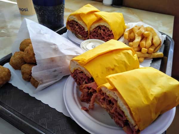 trays of burgers, fries, and onion rings