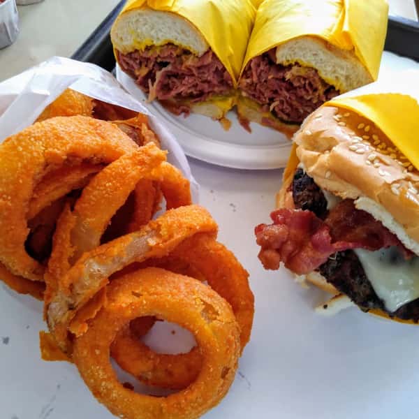 tray of burgers, fries, and onion rings