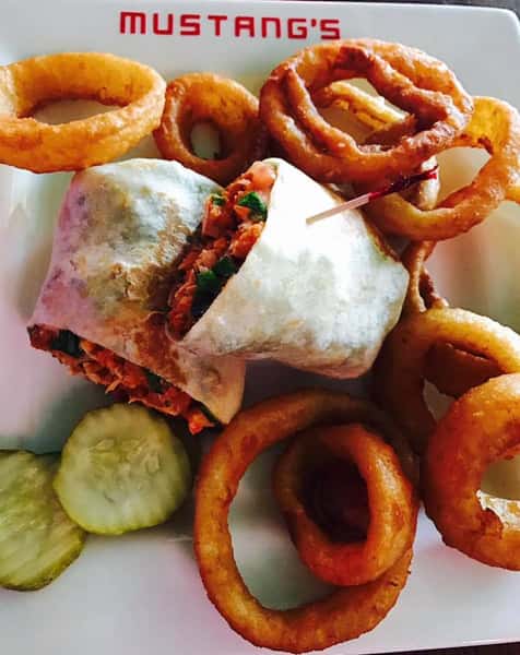 Buffalo Chicken Wrap with side of pickles and onion rings