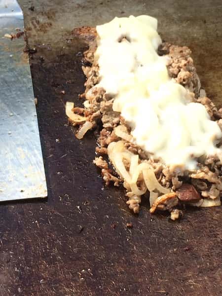 grilled meat topped with cheese