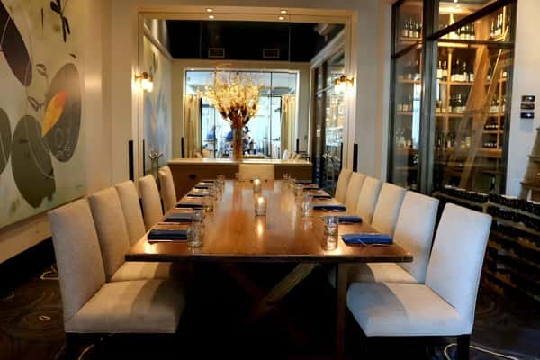 Private dining space with long table seating and upscale décor.