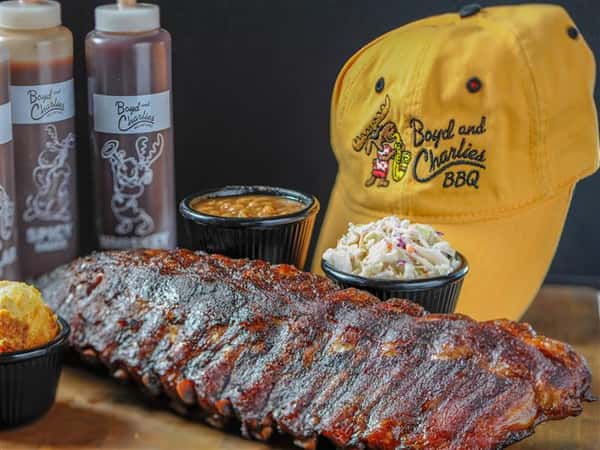 Ribs rubbed with seasonings and slowly smoked, served with beans, side salad, sauces, by a jockey hat
