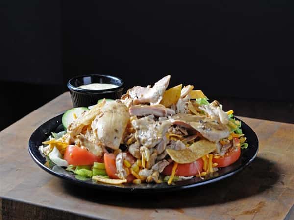 Fresh greens topped with chicken, corn, tomatoes and crispy tortillas, served with creamy dressing
