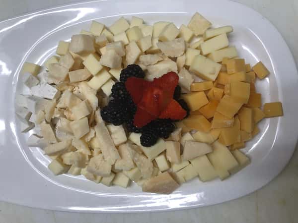 plate of various cheeses with fresh fruit