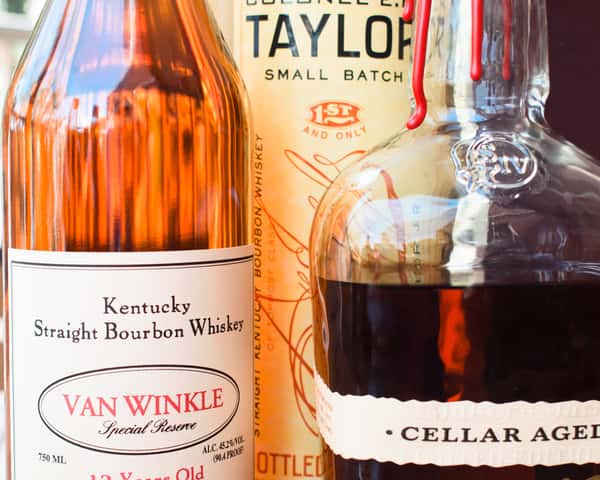 A curated selection of rare bourbons, including Van Winkle and Colonel E.H. Taylor, featured at Lou Lou on Market.