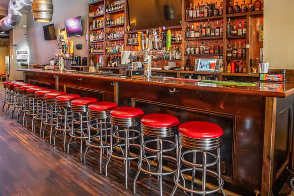 bar area with vintage style red and chrome bar stools