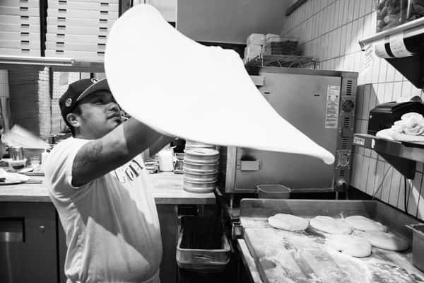 chef throwing pizza dough