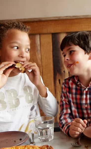 Kids enjoying pizza