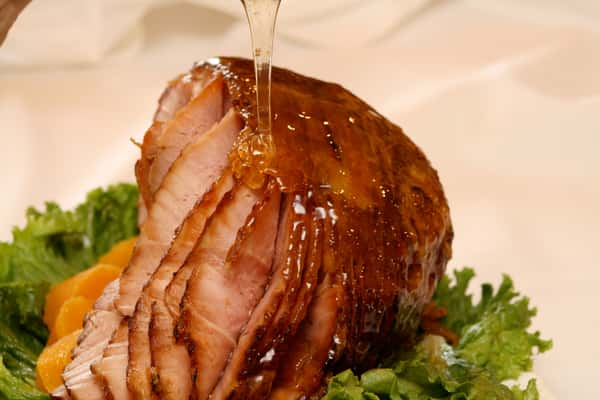 Ham being glazed with honey