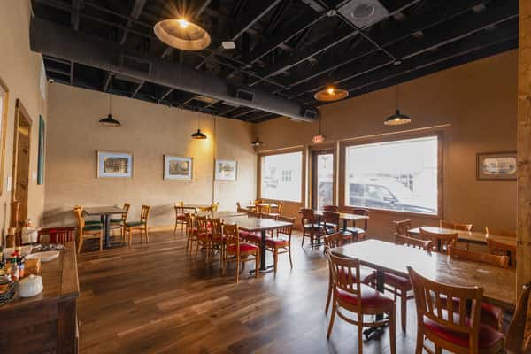 Interior dining space with wooden finishes and warm lighting