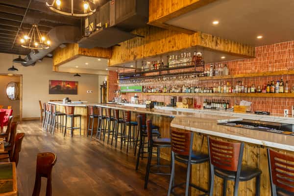 Interior bar area with wooden finishes and drinks