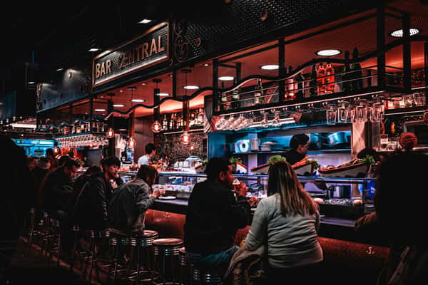 Lively pub scene with customers at a bar table