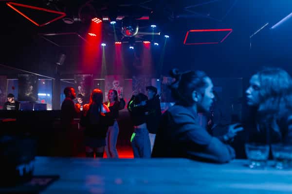 Lively pub scene with customers at a bar table at night