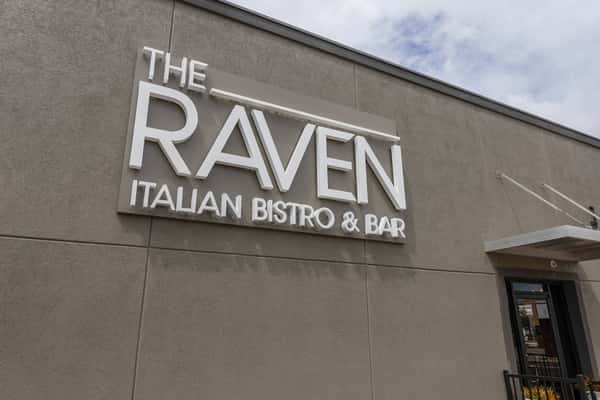Exterior signage with restaurant name on wall