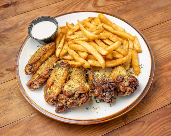 Chicken pieces and fries with sauce