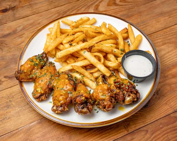 Chicken wings and fries with sauce
