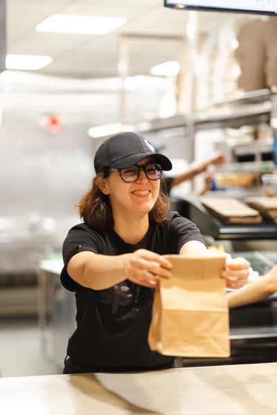 Spoke kitchen staff handing food.