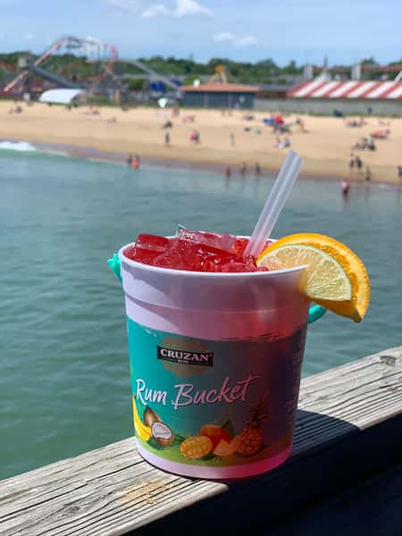 Mixed drink in a bucket in front of an ocean view