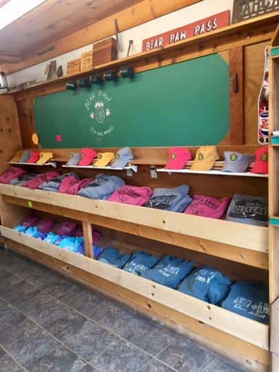 souvenir hats and shirts displayed in shelves