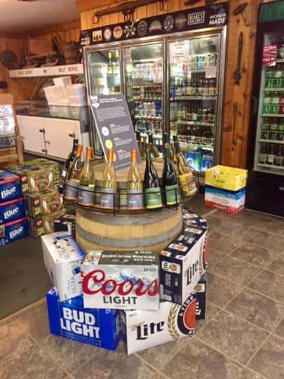 wine bottles and cases of beer being displayed