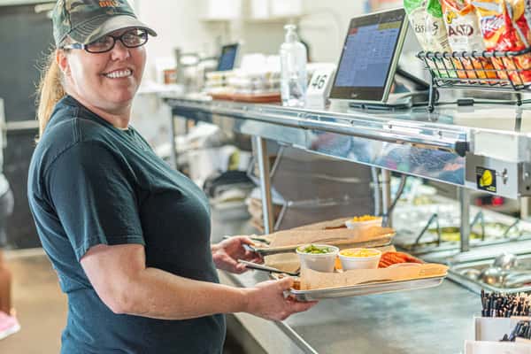 Staff member holding trays