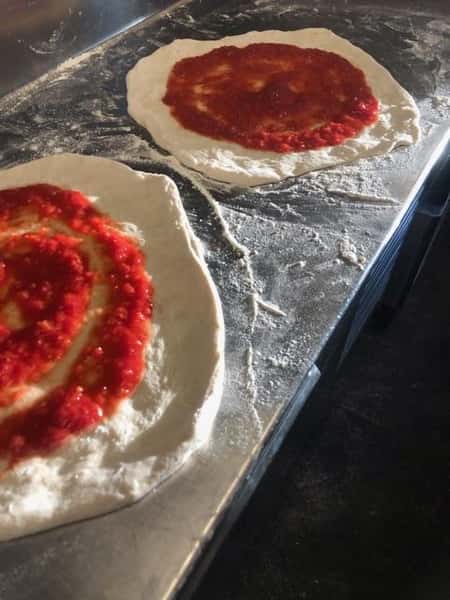 pizza dough topped with sauce