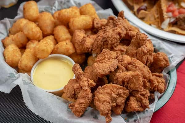 fried chicken bites with hashbrowns and a side of honey mustard