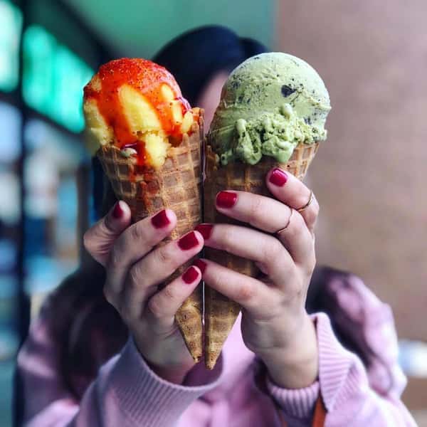 Woman holding two ice cream cones