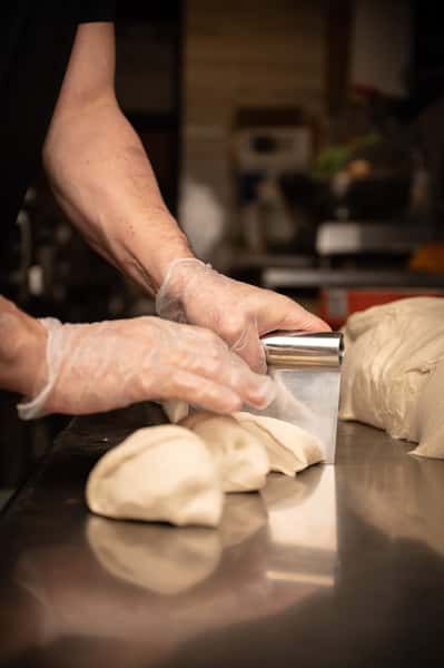 chef cutting dough