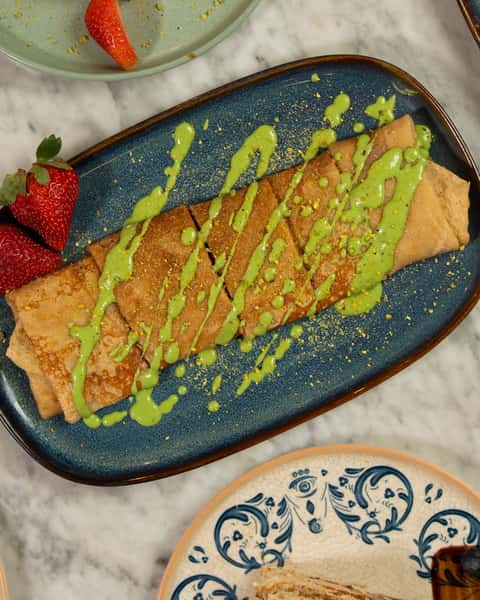 Fresh crepes, finished two ways. 🍓✨

Warm crepes topped with fresh strawberries, one with a pistachio drizzle, one with a rich caramel finish. Both made to slow the night down in the best way.

Which flavor are you choosing?