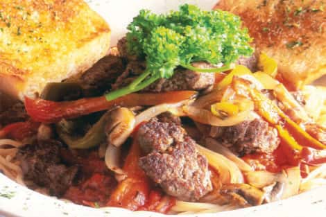 Buffalo meat diced up with grilled peppers, onions, mushrooms on top of sauce with spaghetti, served with garlic bread