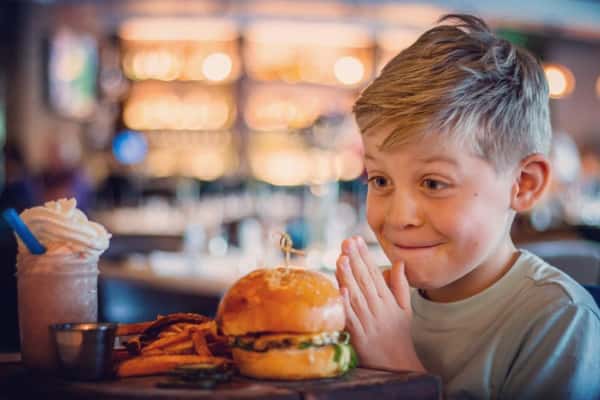 child with burger and fries