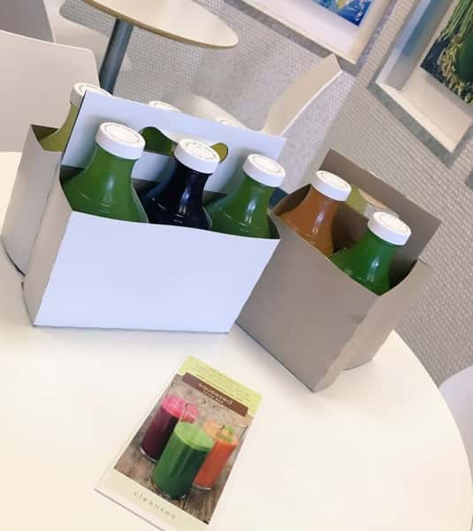 bottles of Squeezed Juice Bar cold-pressed juices in various colors