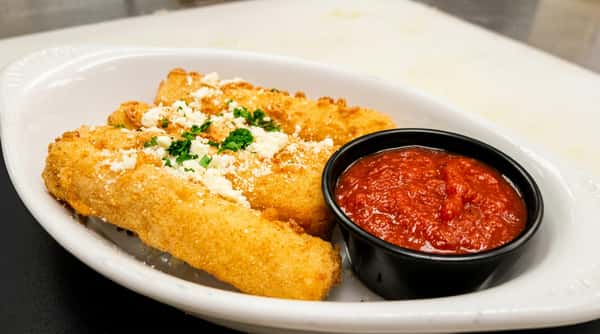 Fried mozzarella sticks sprinkled with white cheese and parsley, served with a side of red marinara sauce.