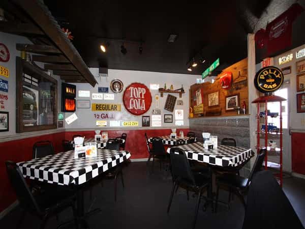 Checkered pattern dining area with walls filled with vintage decorations