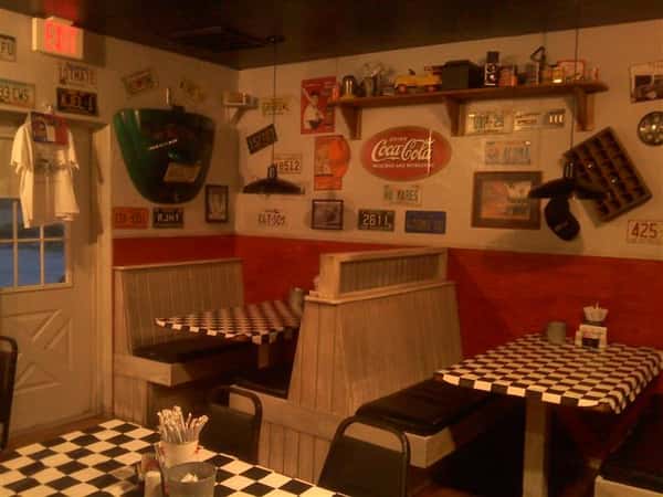 Dining area with walls filled with vintage decorations