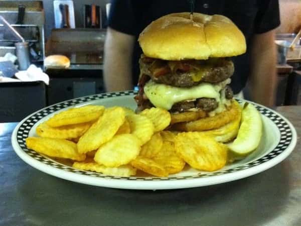 Double bacon cheese burger with a side of chips
