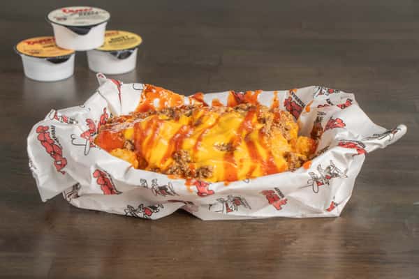 Texas Tom's crispy tater tots loaded with savory chili and melted cheese