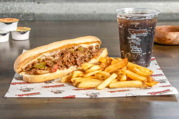 Texas Tom's double cheeseburger combo with fresh toppings, crispy fries, and a soft drink