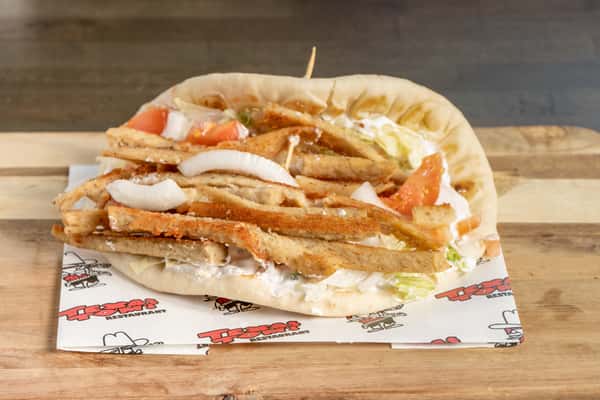 Texas Tom's chicken gyro with seasoned chicken, tomatoes, onions, lettuce, and creamy sauce in warm pita bread