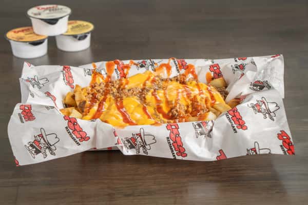 Texas Tom's crispy fries loaded with savory chili and melted cheese